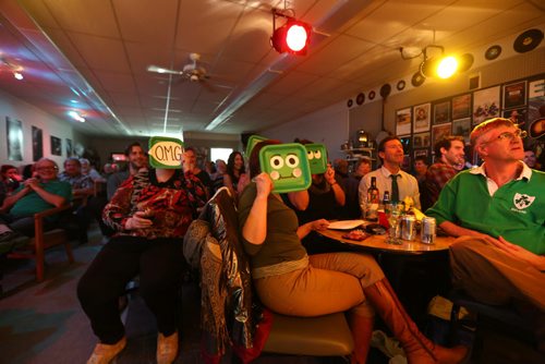 RUTH BONNEVILLE / WINNIPEG FREE PRESS  Locals  cover their faces with masks in fun after listening to some of the 'salty" lyrics performed by musicians onstage at Johnny's, a Cabaret style setting which is a major meeting place in town after a set.    Feature story on the vibrant arts community in Flin Flon Manitoba by reporter, Erin Lebar.    March 19, 2016