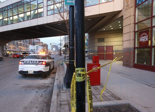 WAYNE GLOWACKI / WINNIPEG FREE PRESS   Police tape marks off a section of the sidewalk along Portage Ave. at Vaughan St. Wednesday morning in front of Portage Place.   March 30 2016