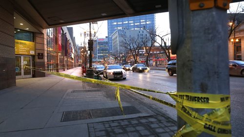 WAYNE GLOWACKI / WINNIPEG FREE PRESS   Police tape marks off a section of the sidewalk along Portage Ave. at Vaughan St. Wednesday morning in front of Portage Place.   March 30 2016