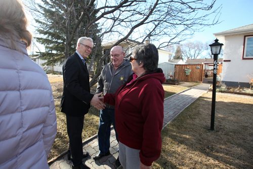 RUTH BONNEVILLE / WINNIPEG FREE PRESS  NDP leader Greg Selinger talks to Elmwood homeowners, Cliff and Bev Bernhardt before holding press conference in front of their home  announcing he will protect Mb. Hydro from privatization and help families save money on utility bills Wednesday. March 30, 2016