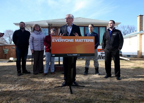 RUTH BONNEVILLE / WINNIPEG FREE PRESS  NDP leader Greg Selinger holds press conference in front of home in Elmwood announcing he will protect Mb. Hydro from privatization and help families save money on utility bills Wednesday.  Names of people standing behind Selinger:  Matt Wiebe - NDP candidate for Concordia, next to him is Erna Braun - NDP candidate for Rossmere, Bev Bernhardt - owner of home behind them (husband is Cliff Bernhardt not seen in pic), Chris Parker with Build Wright Developments and Bernie Wood - far right.    March 30, 2016