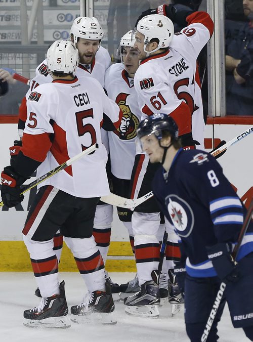 Ottawa Senators' Cody Ceci (5), Mark Stone (61), Jean-Gabriel Pageau (44) and Zack Smith (15) celebrate Smith's goal against Jacob Trouba (8) and the Winnipeg Jets during first period NHL action in Winnipeg on Wednesday, March 30, 2016. THE CANADIAN PRESS/John Woods