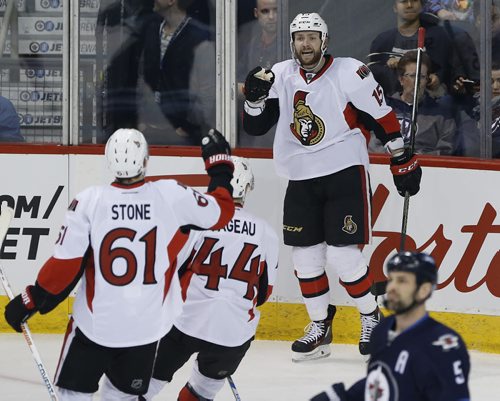 Ottawa Senators' Mark Stone (61), Jean-Gabriel Pageau (44) and Zack Smith (15) celebrate Smith's goal against Mark Stuart (5) and the Winnipeg Jets during first period NHL action in Winnipeg on Wednesday, March 30, 2016. THE CANADIAN PRESS/John Woods
