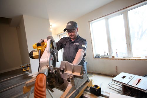 RUTH BONNEVILLE / WINNIPEG FREE PRESS  Jim Gnidziejko works for Habitat for Humanity as a Handyman cutting baseboards in a home on Langside street Thursday.  Habitat launched a support program to help low-income families upkeep their home Thursday.    March 31, 2016