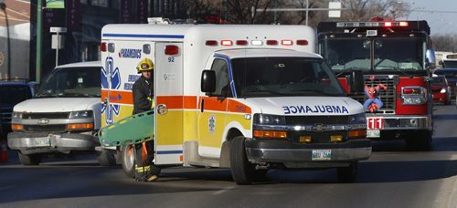 WAYNE GLOWACKI / WINNIPEG FREE PRESS   Winnipeg Fire Paramedics on Portage Ave. at Valour Rd. Friday morning after a pedestrian was struck by a vehicle. The traffic flow in the east bound lanes was reduced to one lane.    April 1  2016