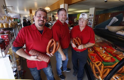 WAYNE GLOWACKI / WINNIPEG FREE PRESS  From right, Walter Klopick and his sons Christian and Zenon at their Tenderloin Meat & Sausage store with samples  of some of the approximately 40 products they make.   Murray McNeill story   April 1  2016