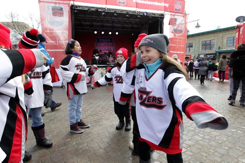 RUTH BONNEVILLE / WINNIPEG FREE PRESS  Dakota Lazers  girls hockey team dance in front of the stage as the band 'All the Kings Men' play during the  Rogers Hometown Hockey Tour at the Forks Saturday.    April 02, 2016