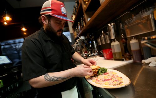 TREVOR HAGAN / WINNIPEG FREE PRESS Chef Frank McCann plating Beef Carpaccio at Close Company for Bartley restaurant review, Saturday, April 2, 2016.