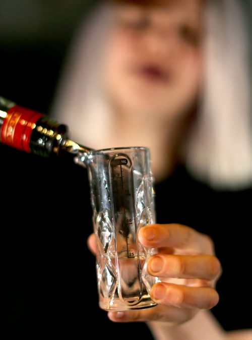 TREVOR HAGAN / WINNIPEG FREE PRESS Elsa Taylor, co-owner and head bartender at The Roost, prepares The Bulletproof, Saturday, April 2, 2016. For Bart Kives review.