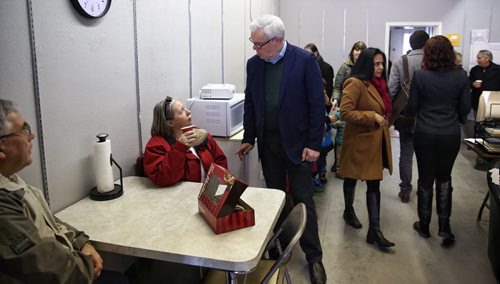 MIKE DEAL / WINNIPEG FREE PRESS  NDP leader Greg Selinger chats with supporter Marilyn Rosaasen before pledging that if elected his government would create a new $25-million capital fund to build public and community-operated child care centres during a stop at MLA hopeful Deanne Crothers campaign offices on Portage Avenue Sunday morning.   160403 April 03, 2016