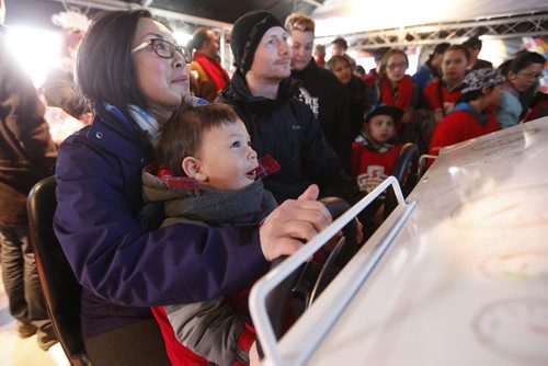 JOHN WOODS / WINNIPEG FREE PRESS Two year old Daniel, with his mom and dad Aileen and Matthew Matwyshyn, plays the Zamboni Challenge at the Hometown Hockey event at The Forks Sunday, April 3, 2016.