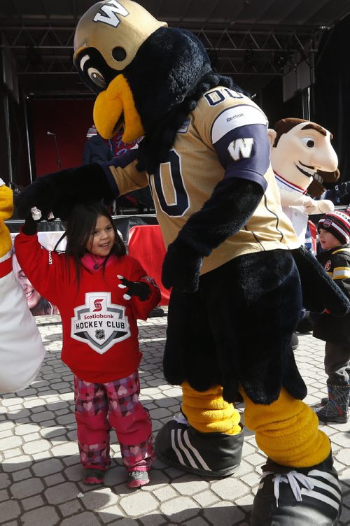 JOHN WOODS / WINNIPEG FREE PRESS Five year old Caydince McIvor dances with Boomer at the Hometown Hockey event at The Forks Sunday, April 3, 2016.