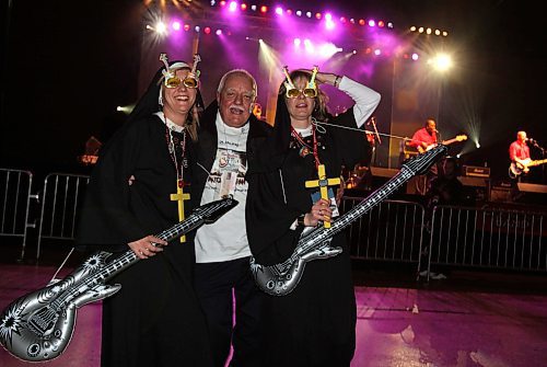 BORIS MINKEVICH/WINNIPEG FREE PRESS  080309 Reggie McLeod of Deep River, Ont. gets down with Darcie Buxton and Maggie Bencharski, sho are dressed up as paryying nuns. Photo taken at the Convention Centre where curlers are partying it up.