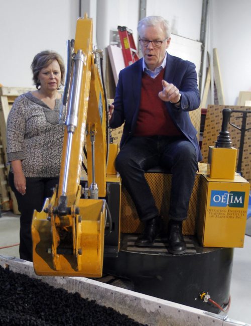 BORIS MINKEVICH / WINNIPEG FREE PRESS NDP makes Trades Announcement at Operating Engineers Training Institute of Manitoba. NDP Leader Greg Selinger has some fun on one of their training machines while OETIM Exec. Dir. Betty Lou Doerksen watches on. April 4, 2016