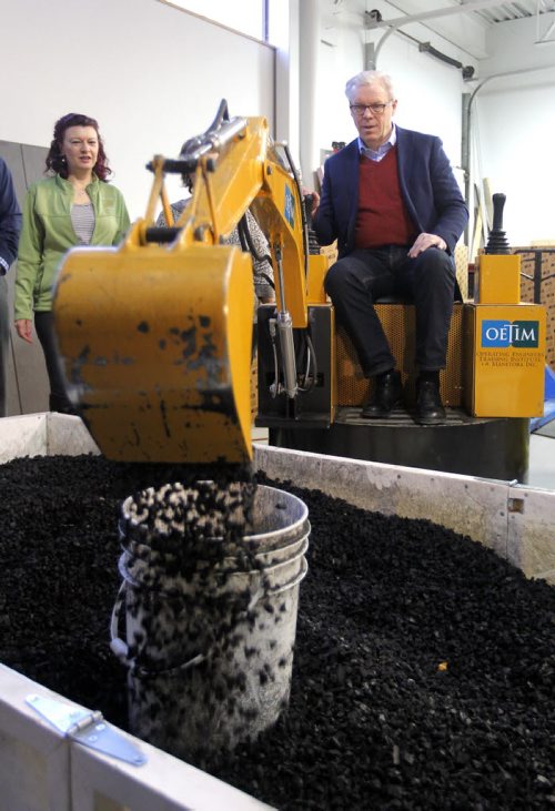 BORIS MINKEVICH / WINNIPEG FREE PRESS NDP makes Trades Announcement at Operating Engineers Training Institute of Manitoba. NDP Leader Greg Selinger has some fun on one of their training machines. Left in green is NDP candidate for Kirkfield Park  Sharon Blady. April 4, 2016