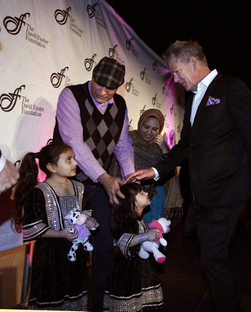 At an event at the CMHR, at rght Grammy Award-winning producer David Foster puts his hand on the head of Nazdana Jan,3, who was born in Portage La Prairie in 2012 with an urea cycle disorder. She is with her father Jouhar Ali and mother Alia Jouhar  and her older sister Paghunda. In 2013, The David Foster Foundation was able to assist the family after they had returned back to Winnipeg from Calgary with flights, accommodation, transportation and meals to attend the liver transplant assessment at Toronto Sickkids Hospital since there was no transplant program in Manitoba. Nazdana was listed for a liver transplant, and on April 22, 2014 she was given the gift of life when she finally received the liver she so desperately needed. The David Foster Foundation was able to continue supporting the family while they were required to temporarily relocate to Toronto for liver transplant. Throughout Nazdanas recovery there have been many readmissions to hospital, and follow up medical appointments. Although the province of Manitoba was able to reimburse the family for the patient and one parents flight, the family was required to cover the additional costs. At the event Monday¤David Foster announced his upcoming¤2016 David Foster Foundation Miracle Gala & Concert ¤Sept. 24¤in Winnipeg.¤ Erin Lebar story. WAYNE GLOWACKI / WINNIPEG FREE PRESS April 4 2016  