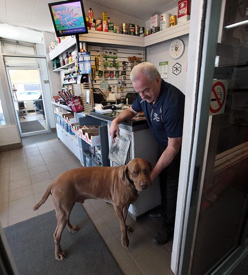 PHIL HOSSACK / WINNIPEG FREE PRESS Jeff Kendal spends in a quiet moment with his pooch at his family corner gas station.  Jeff Kendall talks to Kelly Taylor re; The death of the corner gas station. Kendel was a Shell dealer, dumped Shell for Esso and then ended gas sales altogether, squeezed by a sales model that leaves retailers pumping gas for zero profit or, often, a loss. See story 49.8 - April 4, 2016