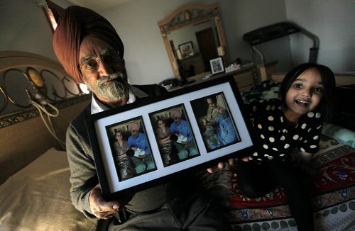 PHIL HOSSACK / WINNIPEG FREE PRESS Darshan Singh shows off portraits of his late wife Mohinder and himself in happier days. Grand-daughter Ariya (3) plays beside him. See Randy Turner Story. - April 4, 2016