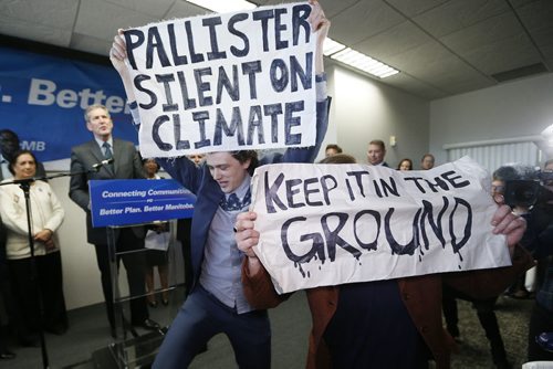 JOHN WOODS / WINNIPEG FREE PRESS Environmentalists Riley McMurray and Natalie Dyck interrupt Manitoba PC leader Brian Pallister as he addresses supporters at a party rally in a Winnipeg hotel Monday, April 4, 2016.