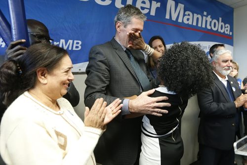 JOHN WOODS / WINNIPEG FREE PRESS Kenny Daodu wipes her lipstick from Brian Pallister's lips after she kissed the Manitoba PC leader at a party rally in a Winnipeg hotel Monday, April 4, 2016.