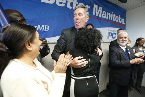 JOHN WOODS / WINNIPEG FREE PRESS Manitoba PC leader Brian Pallister reacts after Kenny Daodu (R) wiped her lipstick from his lips after she kissed him at a party rally in a Winnipeg hotel Monday, April 4, 2016.