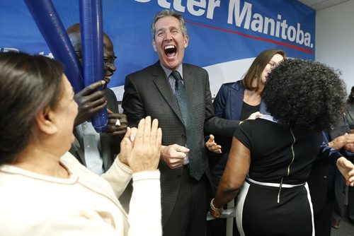 JOHN WOODS / WINNIPEG FREE PRESS Manitoba PC leader Brian Pallister laughs after Kenny Daodu (R) wiped her lipstick from his lips after she kissed him at a party rally in a Winnipeg hotel Monday, April 4, 2016.