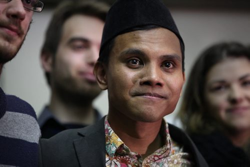 RUTH BONNEVILLE / WINNIPEG FREE PRESS  Malaysian student Hazim Ismail is overwhelmed with joy as he is hugged by friends and supporters  outside the refugee hearing office in Winnipeg Tuesday morning after winning his case against being deported back to Malaysia where he had been given death threats due to his sexual orientation.   See Carol Sanders story.      April 05, 2016