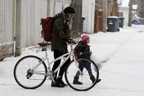 BORIS MINKEVICH / WINNIPEG FREE PRESS Weather photo - Courtney Gilchrist pushes her bike with her daughter Ivy, 4, down Wolseley Ave. Ivy is in Kindergarten and school just finished. April 5, 2016