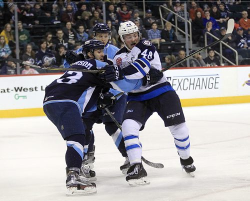 PHIL HOSSACK / WINNIPEG FREE PRESS Brendan Lemieux #48 works the front of the Millwaukee Admiral net against #23 Taylor Aronson in his professional debut Tuesday with the Manitoba Moose. See story. - April 5, 2016