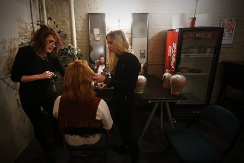 JOHN WOODS / WINNIPEG FREE PRESS Aiden Moore, bass player, gets a fine tuning on his wig by stylists Judi Olson Chiswell (L) and Mazena Puksto backstage prior to hitting the stage in A Night With Janis Joplin in Winnipeg Tuesday, April 5, 2016.