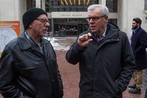 MIKE DEAL / WINNIPEG FREE PRESS NDP leader Greg Selinger chats with media before outlining a plan to create an inner ring road, move rail lines and share costs 50/50 with federal government during a campaign announcement outside City Hall Wednesday morning. 160406 - Wednesday, April 06, 2016