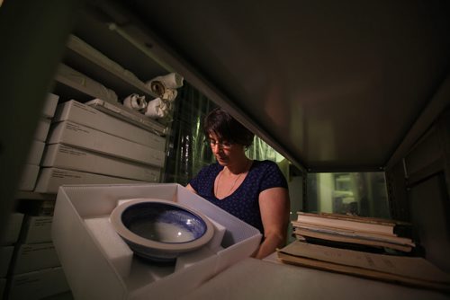 RUTH BONNEVILLE / WINNIPEG FREE PRESS  Andrea Reichert, curator of the Manitoba Crafts Museum and Library on Kennedy holds a bowl created by Janice Howorth that is just one of the hundreds of items being packed up and moved to a new location near the Exchange District.   See Alan Small's story.    April 06, 2016