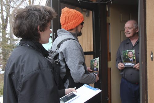 BARTLEY KIVES / WINNIPEG FREE PRESS Gimli NDP candidate Armand Bélanger (centre) and volunteer Jersey Sundseth chat with supporter Rick Morrison in Ponemah, Man. on Friday, April 1, 2016.