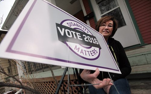 PHIL HOSSACK / WINNIPEG FREE PRESS Disability Matters Natalie Mulaire holds a "Disability Matters Vote" sign she has planted on her front yard. See Kevin Rollason story re Voting for the disabled.  April 6, 2016