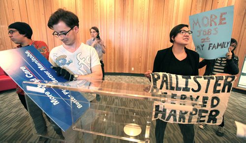 PHIL HOSSACK / WINNIPEG FREE PRESS Sadie-Pheonix Lavoie (right) and other activists waited in vain to confront Brian Pallister about child care issues Thursday. When he didn't show they took over the Conservative leader's podium and sign. See Larry Kusch story. APRIL 7, 2016