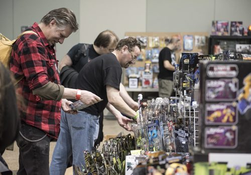DAVID LIPNOWSKI / WINNIPEG FREE PRESS   Ben Kuehner browsing Star Wars merchandise at the Winnipeg Pop Culture Expo at the Convention Centre Saturday April 9, 2016.