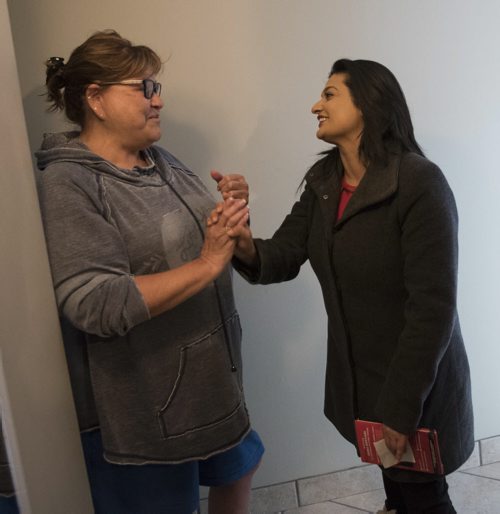 DAVID LIPNOWSKI / WINNIPEG FREE PRESS   Manitoba Liberal Party leader Rana Bokhari and Federal Minister Jim Carr greet former RCMP officer Marge Hudson while door knocking on the first day of advance voting Saturday April 9, 2016 in an apartment building on Wellington Crescent.