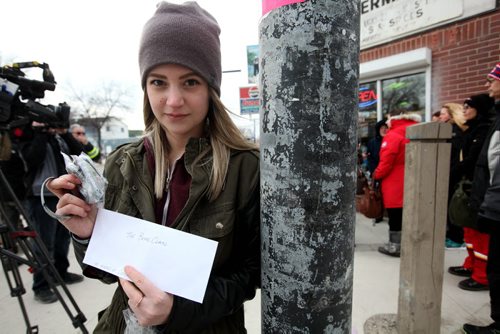 RUTH BONNEVILLE / WINNIPEG FREE PRESS  Twenty-year-old Paige Buors holds a cheque for $2,337.00 that she is presenting to the Bear Clan for the 3,100 bracelets she made from fundraising for Cooper Nemeth causes at the Bell Tower Saturday afternoon.  See Alex Paul story.     April 09, 2016