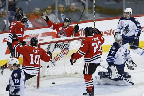 JOHN WOODS / WINNIPEG FREE PRESS Manitoba Moose goaltender Conor Hellebuyck (37) reacts as Rockford Icehogs' Cameron Schilling (5), Tanner Kero (10), Tyler Motte (37) and Pierre-Cedric Labrie (22) celebrate Schilling's goal during first period AHL action in Winnipeg on Sunday, April 10, 2016.