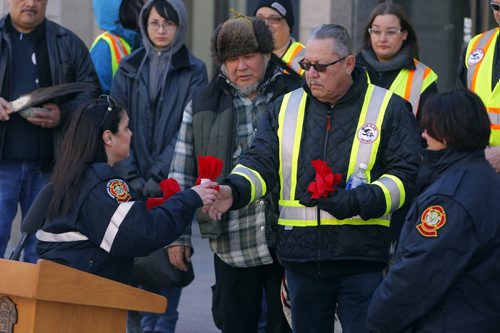 BORIS MINKEVICH / WINNIPEG FREE PRESS Smudging Ceremony led by the Bear Clan Patrol to celebrate 2016 National Public Safety Telecommunicators Week. His Worship, Mayor Brian Bowman and Chief John Lane, Winnipeg Fire Paramedic Service was there. Event held at City Hall courtyard  510 Main Street. Here the WFPS gives the Bear Clan some tobacco. April 11, 2016 -30-
