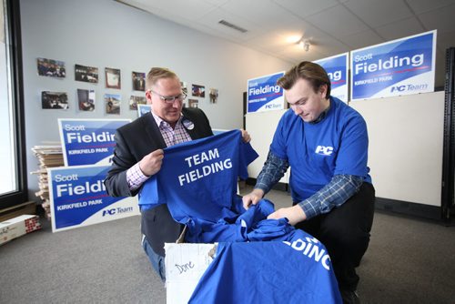 RUTH BONNEVILLE / WINNIPEG FREE PRESS
Scott Fielding, PC candidate for Kirkfield Park unpacks t-shirts that arrived at their office Tuesday with help of James Toker.

April 12/2016