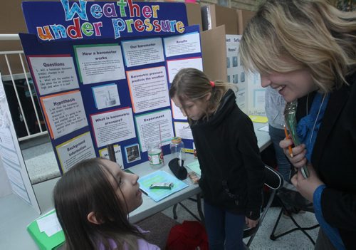 JOE BRYKSA / WINNIPEG FREE PRESS  The Winnipeg Schools showcased their students best science fairs at the 46th Annual  Winnipeg Schools Science Fair at the Brodie Centre Judge Alison Gareu talks with Robert H Smith  Grade 5 students Rose McLeod, left, and Klara Stokke about their project called Weather Under Pressure- Awards will be presented to the winners this Saturday at the Frederic Gaspard Theatre ,University of Manitoba-  March 21, 2016.(Standup Photo)