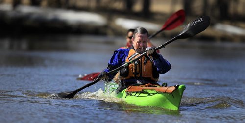 PHIL HOSSACK / WINNIPEG FREE PRESS Spring Paddle - Kurt Penner surfaces as he rolls his kayak up and out of the still frigid waters of the LaSalle River, Judy Wilson watches from behind ready to help as Kurt refeshes his skills after a winter off the water. Both experienced paddlers set out between leftover ice flows on the LaSalle River at LaBarrier Park to take advantage of the double digit temperatures Wednesday afternoon.  APRIL 13, 2016