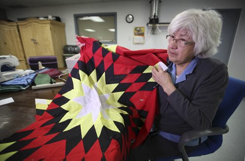 RUTH BONNEVILLE / WINNIPEG FREE PRESS  Mary Lathlin comments on Thursday's Supreme Court ruling that Canada has the same responsibility to Metis and non-status Indians as it does to registered Indians under the Constitution, while working on a star blanket at the Aboriginal Seniors Resource Centre Thursday.     April 14, 2016