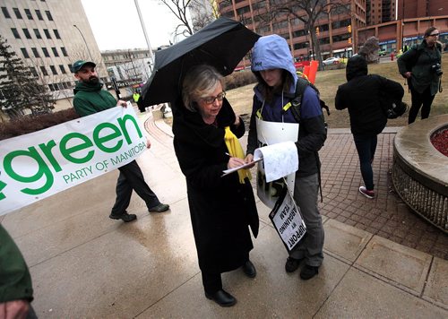 PHIL HOSSACK / WINNIPEG FREE PRESS National Green Party leader Elizabeth May signs a petition in support of a $15 minimum wage Friday at a rally outside U of W. See story..  APRIL 15, 2016