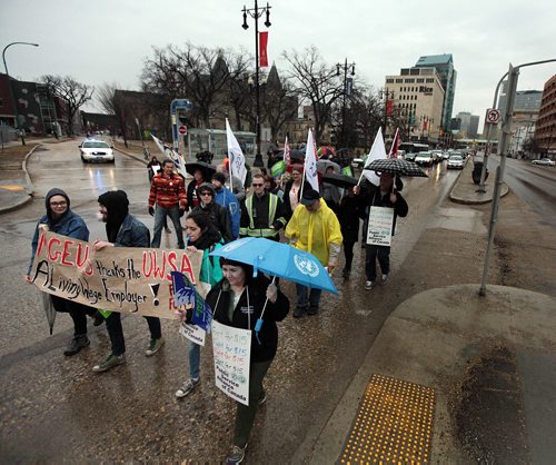 PHIL HOSSACK / WINNIPEG FREE PRESS Rallyer's march down Portage ave from the U of W  to support a $15 minimum wage Friday at noon. See story. APRIL 15, 2016
