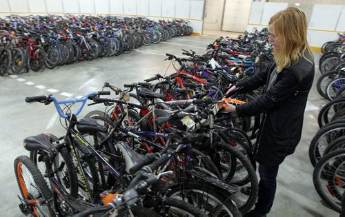 BORIS MINKEVICH / WINNIPEG FREE PRESS Marcia Fifer, liscencing coordinator with community bylaw enforcement services helps organize and tag some of the 706 bikes at the upcoming City of Winnipeg bike auction to be held this weekend. The City?s annual unclaimed bike auction will be held this weekend at the East End Arena, 517 Pandora Avenue East: ·         Saturday, April 16: o   7:00 a.m. to 8:45 a.m. ? public viewing o   9:00 a.m. ? auction begins o   400 bicycles will be up for auction ·         Sunday, April 17: o   10:00 a.m. to 11:45 a.m. public viewing o   12:00 p.m. ? auction begins o   706 bicycles available for auction The City of Winnipeg has again partnered with the WRENCH to offer over 250 ready-to-ride bikes tuned up through the WRENCH's UpCycle employment training program. Every time you bid on a WRENCH ready-to-ride bike you're supporting community bicycle programming across Winnipeg. Please note that all bicycles are sold as is, where is, and no warranty is given nor implied. Cash, MasterCard, Visa, American Express and Interac payments will be accepted. Cheques will not be accepted. One-time bicycle registrations will be available on site at a cost of $6.40 per bicycle. Registering your bike will ensure that, should the City recover it, you will get it back with no additional charges. For further information on Community By-law Enforcement Services - Bicycle Recovery Section, please call 311 or visit City of Winnipeg ? 2016 Bike Auction. For more information on the Winnipeg Repair Education and Cycling Hub (WRENCH) and upcoming workshops, visit the WRENCH website at thewrench.ca.  April 15, 2016