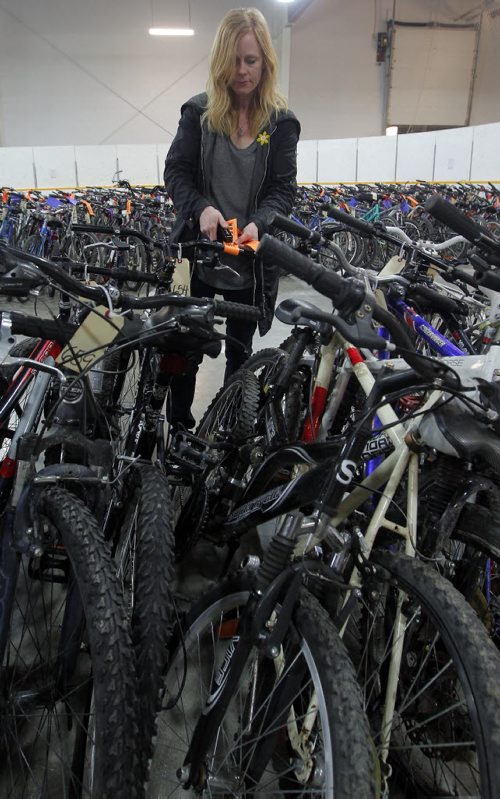 BORIS MINKEVICH / WINNIPEG FREE PRESS Marcia Fifer, liscencing coordinator with community bylaw enforcement services helps organize and tag some of the 706 bikes at the upcoming City of Winnipeg bike auction to be held this weekend. The City?s annual unclaimed bike auction will be held this weekend at the East End Arena, 517 Pandora Avenue East: ·         Saturday, April 16: o   7:00 a.m. to 8:45 a.m. ? public viewing o   9:00 a.m. ? auction begins o   400 bicycles will be up for auction ·         Sunday, April 17: o   10:00 a.m. to 11:45 a.m. public viewing o   12:00 p.m. ? auction begins o   706 bicycles available for auction The City of Winnipeg has again partnered with the WRENCH to offer over 250 ready-to-ride bikes tuned up through the WRENCH's UpCycle employment training program. Every time you bid on a WRENCH ready-to-ride bike you're supporting community bicycle programming across Winnipeg. Please note that all bicycles are sold as is, where is, and no warranty is given nor implied. Cash, MasterCard, Visa, American Express and Interac payments will be accepted. Cheques will not be accepted. One-time bicycle registrations will be available on site at a cost of $6.40 per bicycle. Registering your bike will ensure that, should the City recover it, you will get it back with no additional charges. For further information on Community By-law Enforcement Services - Bicycle Recovery Section, please call 311 or visit City of Winnipeg ? 2016 Bike Auction. For more information on the Winnipeg Repair Education and Cycling Hub (WRENCH) and upcoming workshops, visit the WRENCH website at thewrench.ca.  April 15, 2016