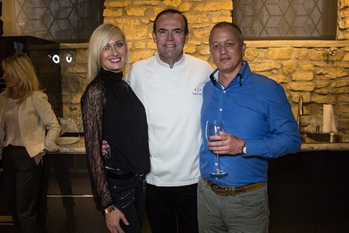 MIKE DEAL / WINNIPEG FREE PRESS Charlie Palmer, New York celebrity chef did a private demo for folks from a Winnipeg company called Magellan Hotels at the Kitchen Sync Thursday evening. Magellan Luxury Hotels president Dan Davidson (right) and his wife Shaleen Davidson with chef Charlie Palmer. 160414 - Thursday, April 14, 2016