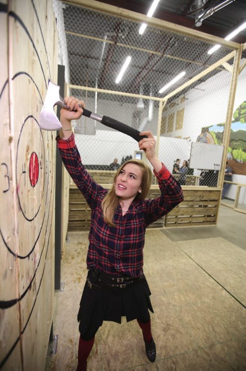 RUTH BONNEVILLE / WINNIPEG FREE PRESS  Intersection piece on Bad Axe, a biz that invites folks to come on down and fire axes at wooden targets. (these are small hatchet type axes you throw with both hands over your head - sort of the way you inbound a ball in soccer. Manager starting up this outlet Melaine Williamson demonstrates to newcomers.    April 16, 2016